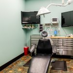 Small image of green patient room with chair and equipment.